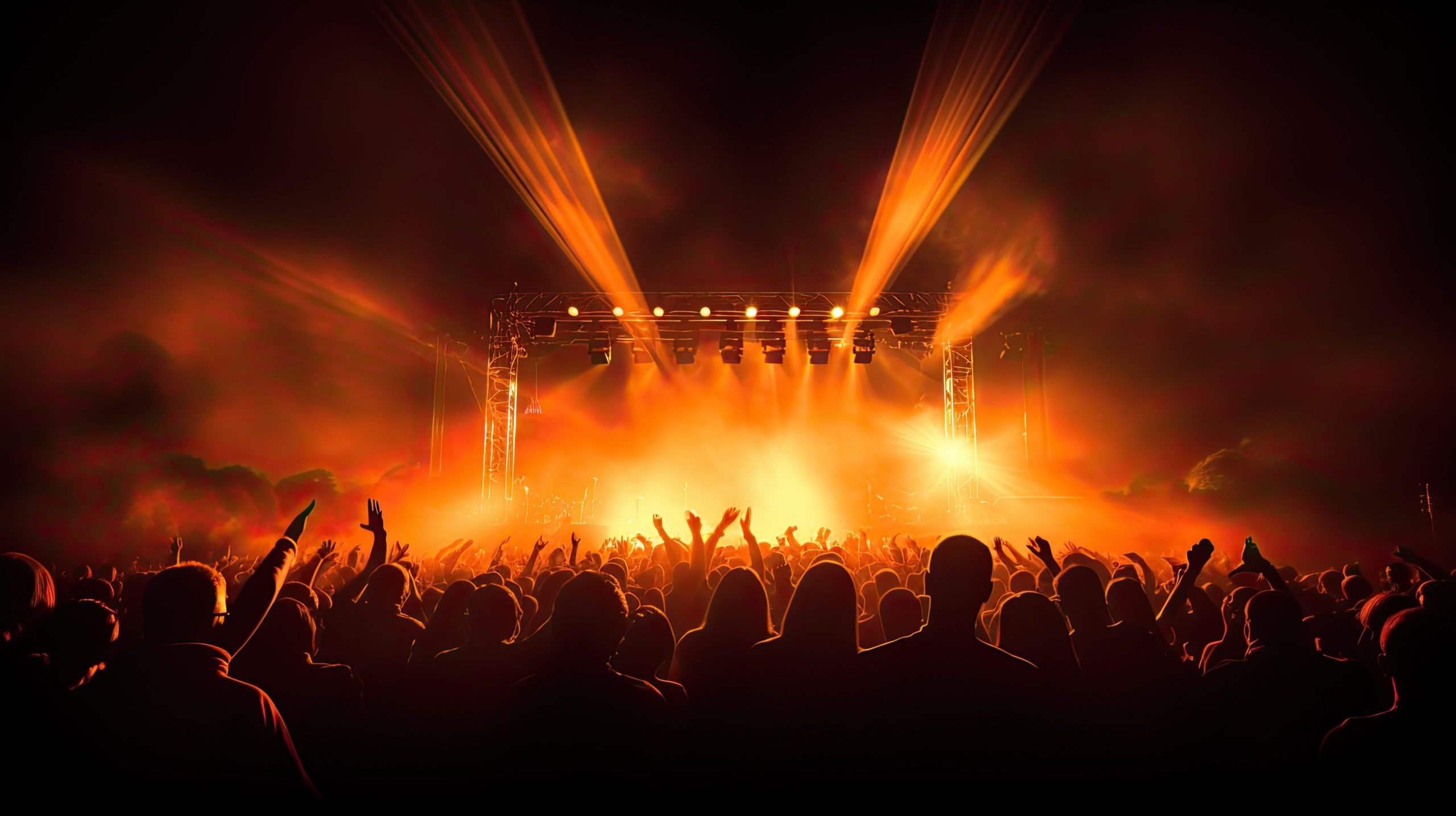 Crowd silhouettes against stage lights